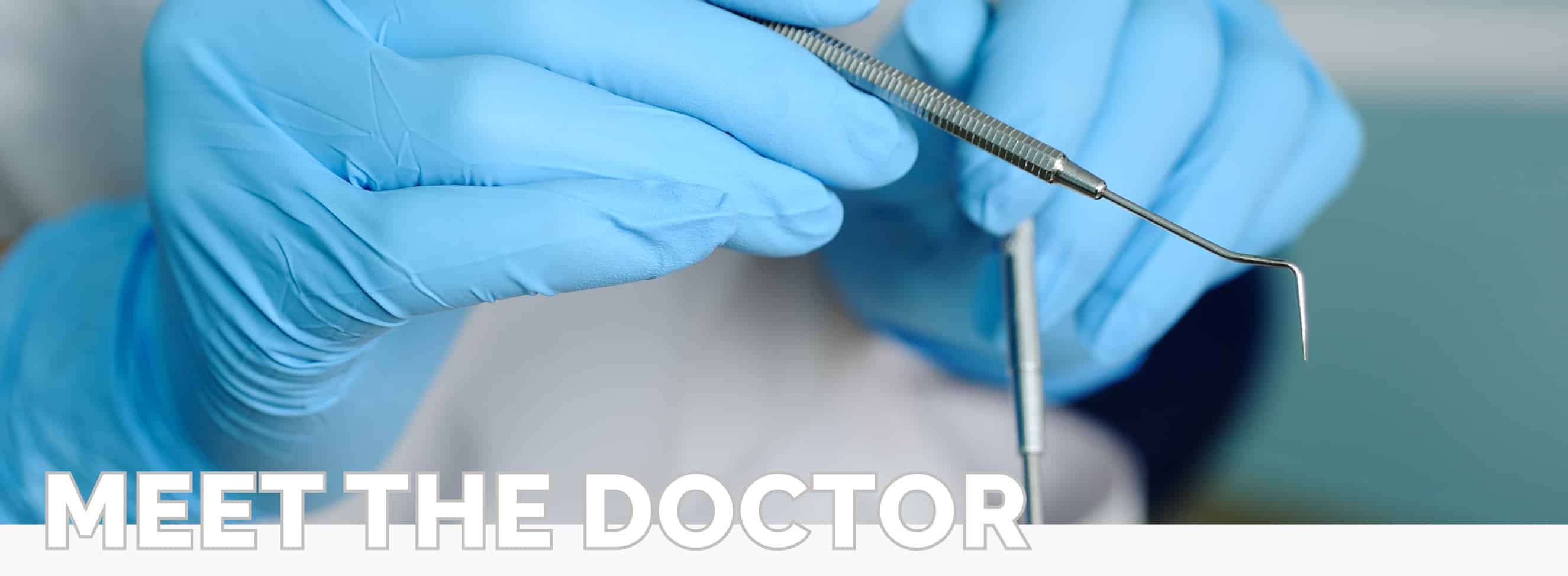 A dentists hands holding some dental tools with the text, "Meet the Doctor" at Kelly Family Dentistry