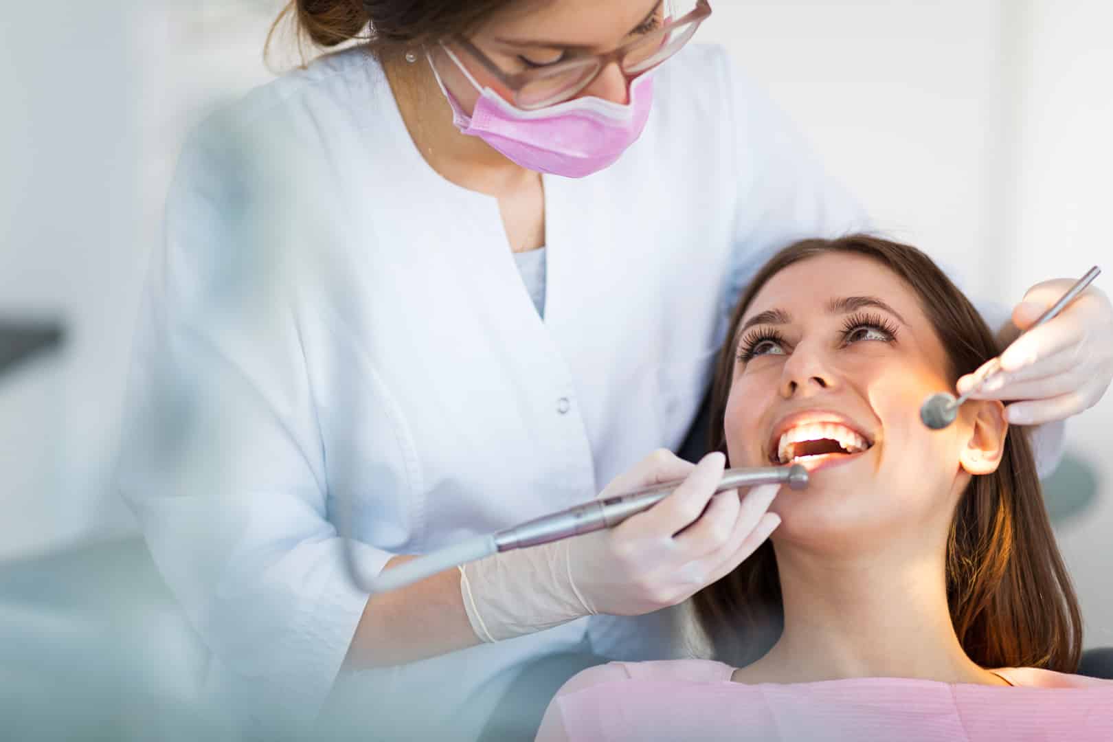 A dentist examining a patient at Kelly Family Dentistry
