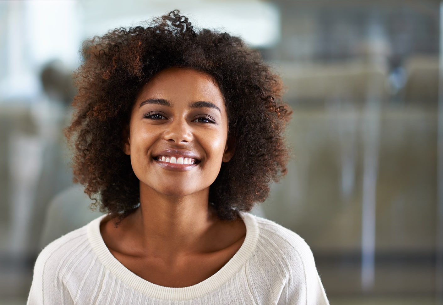 woman inside kelly family dentistry smiling after Teeth Whitening Treatment in Franklin TN