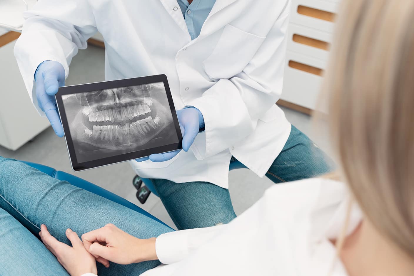 dr kelly showing a dental patient their dental xray during oral exam at kelly family dentistry