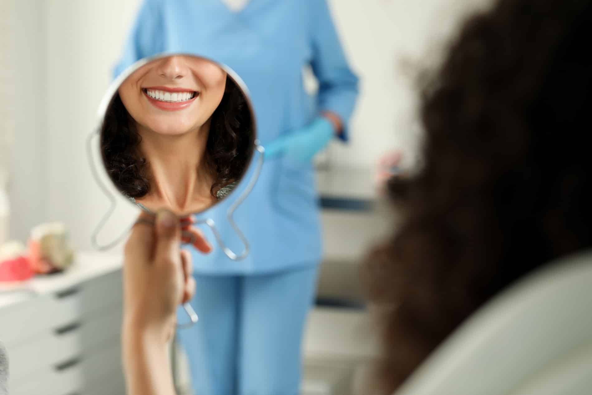 Woman looking at her new smile with dental implants in Franklin TN