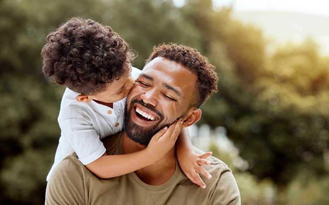 Father and son laughing after family dental care in Franklin TN