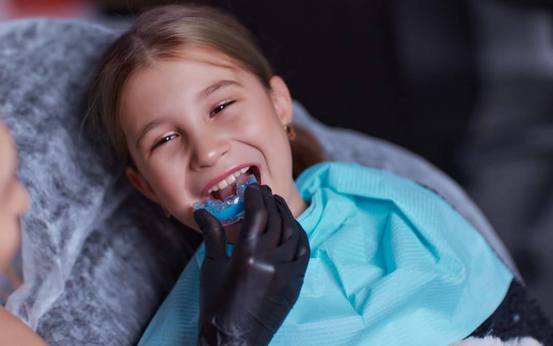 Child trying out a custom guard at the dentist in Franklin TN