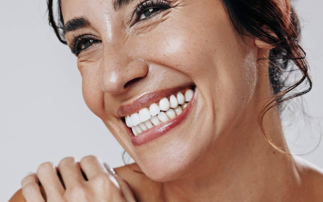 Woman smiles wide with white teeth after teeth whitening treatment in Franklin TN